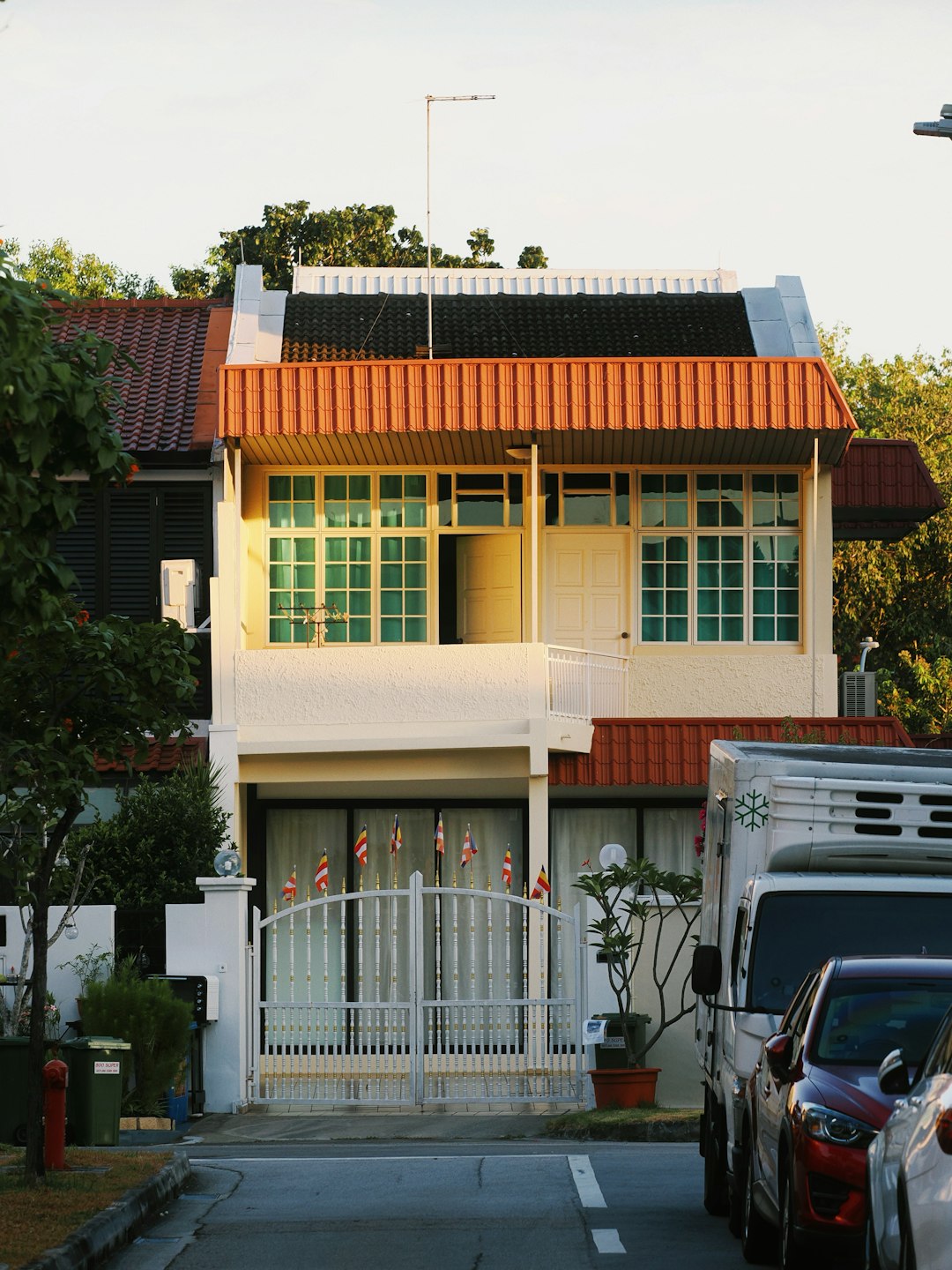 a-two-story-house-with-orange-trim-and-green-windows-dfq5ju-5cly